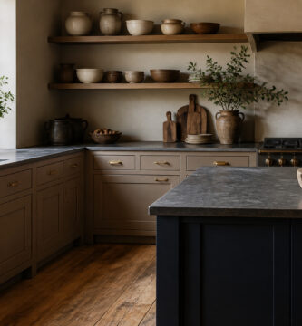 A kitchen with taupe cabinets and white countertops and accessories.